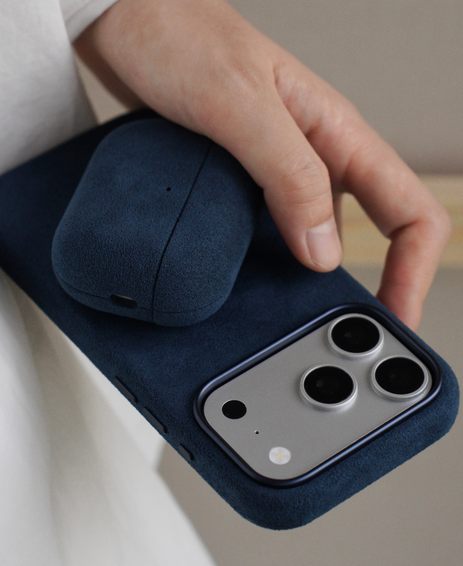 Cantaracase Alcantara iPhone case and AirPods case in hand